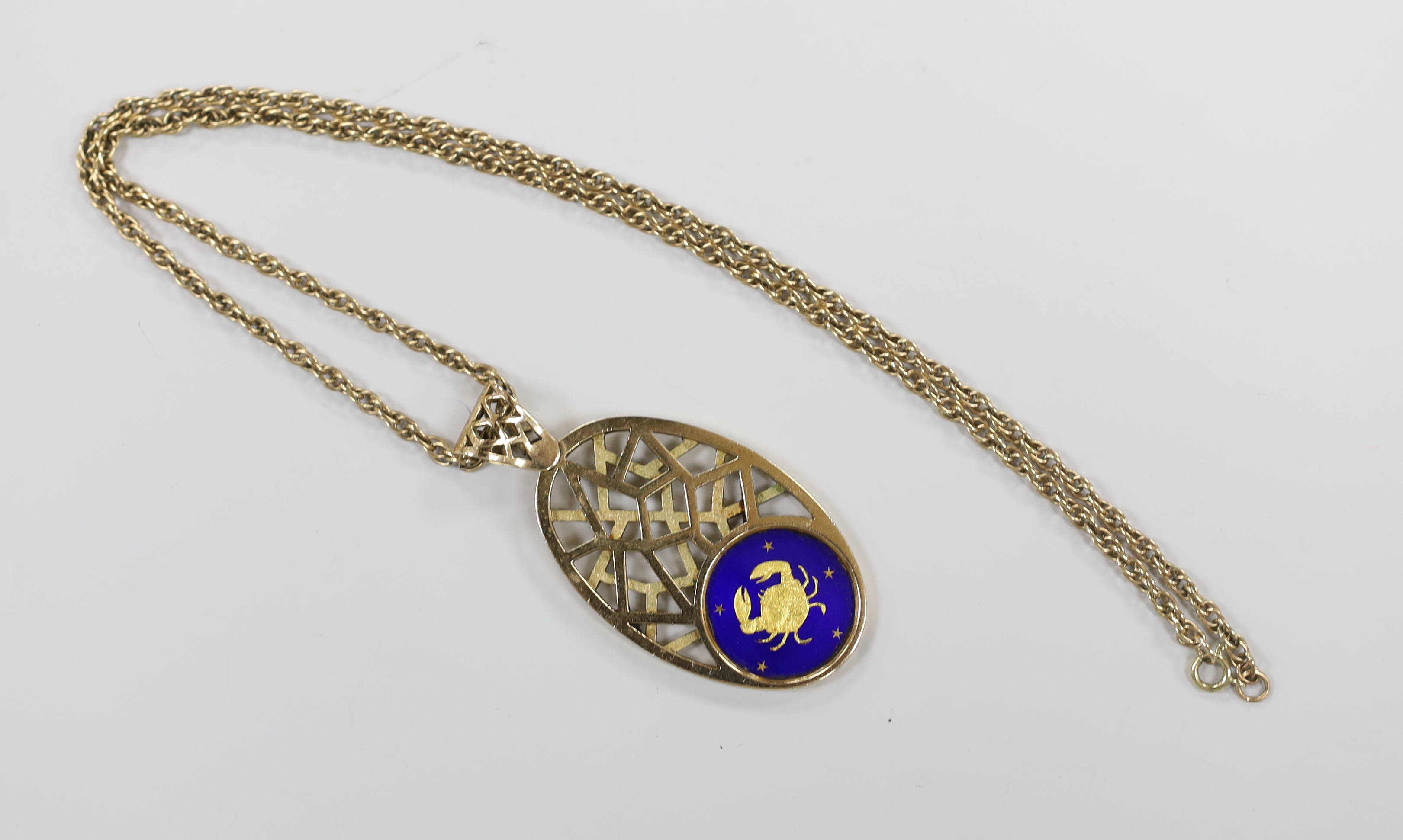 A 1970's pierced 9ct yellow gold and enamel sign of the zodiac oval pendant depicting Cancer, 74mm, gross weight 33.3 grams, on an associated yellow metal chain, 64cm, 18 grams.